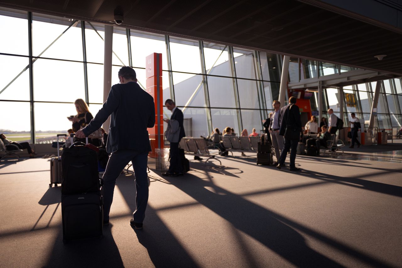 Passageiros com bagagem em terminal de embarque durante viagem a trabalho