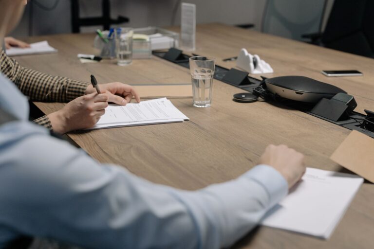 Trabalhador assinando documento de demissão sob pressão da empresa