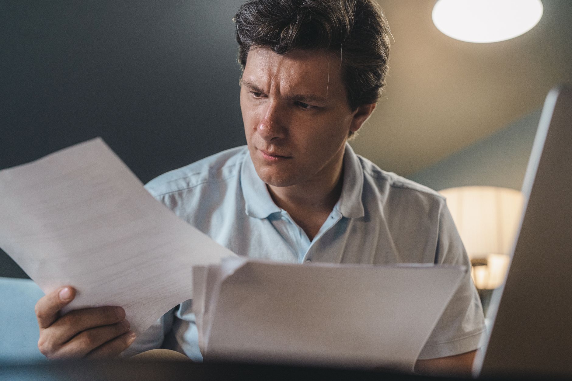 Trabalhador lendo documentos da rescisão e do plano de saúde