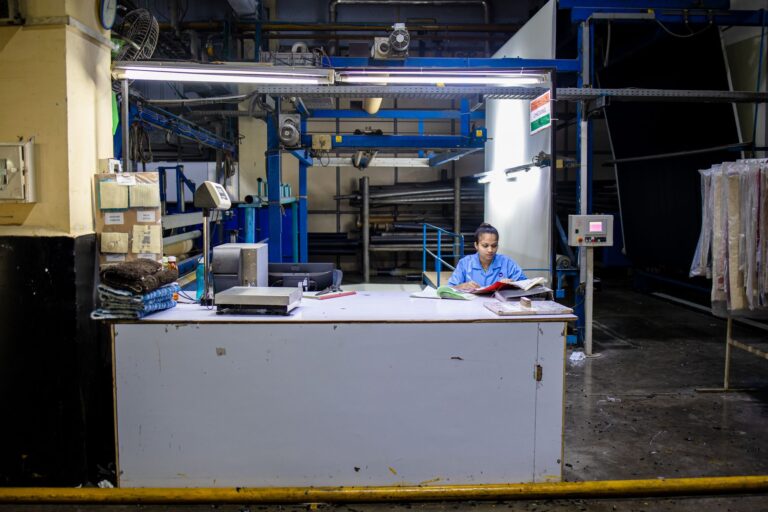 Trabalhador de fábrica lendo documentos em uma mesa