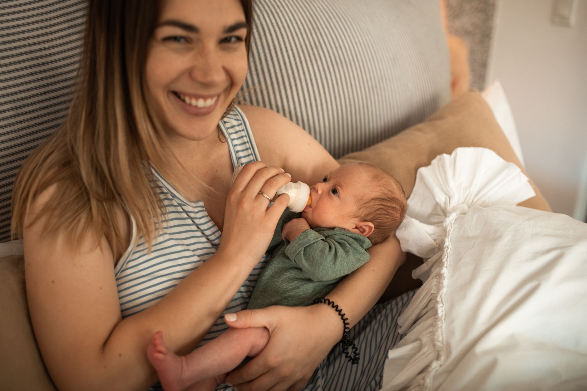 Mãe segurando bebê recém-nascido no colo