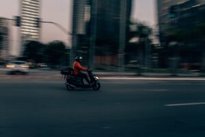 Motorista de aplicativo de entrega em motocicleta na cidade